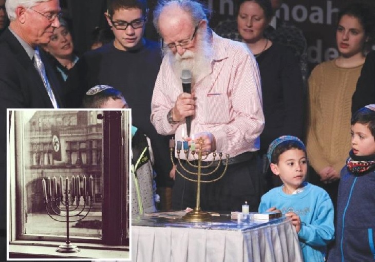 Grandson lighting menorah at Yad Vashem
