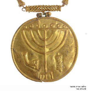 This golden medallion featuring inscriptions of a menorah, shofar, and Torah scroll was on display for the very first time during the the City of David Foundation's annual conference on Sept. 4 in Jerusalem. The medallion was found in the Ophel excavation south of the Temple Mount and was believed to have been hung on a Torah scroll as a breast plate. Credit: Eilat Mazar/City of David Foundation.