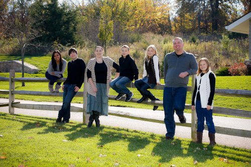 (From left to right): Marchick's adopted daughter Lenora, 20; Tyler, 18; Rose Marchick; Jacob, 10; Lily, 12; husband Clint; and adopted daughter Dasha, 13.