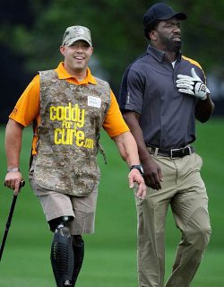 Sgt. Brian Mast caddying for Ed Reed
